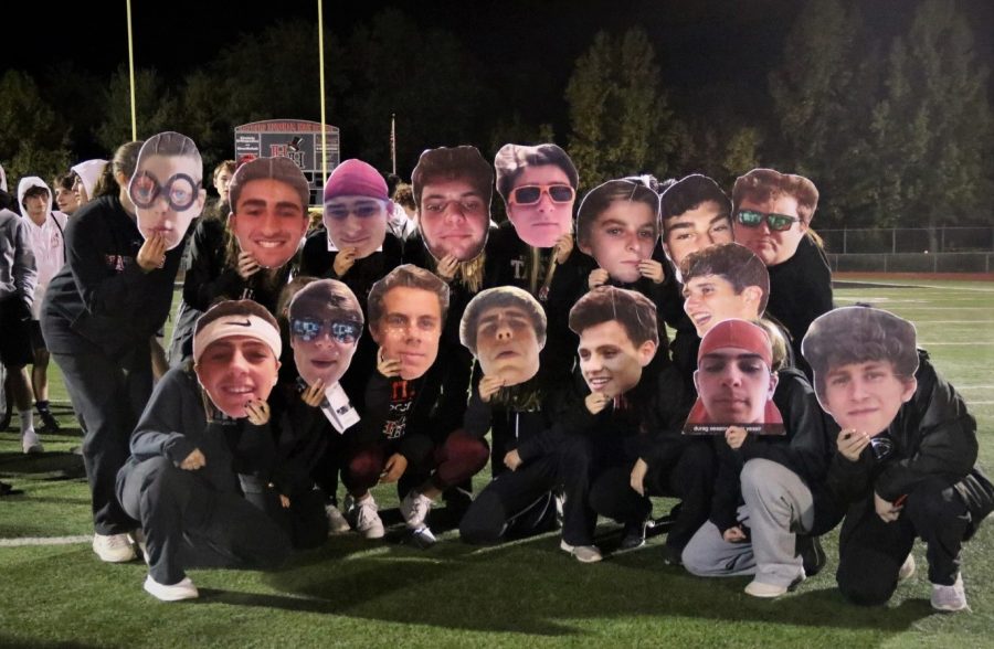 Students holding fat heads of each soccer players