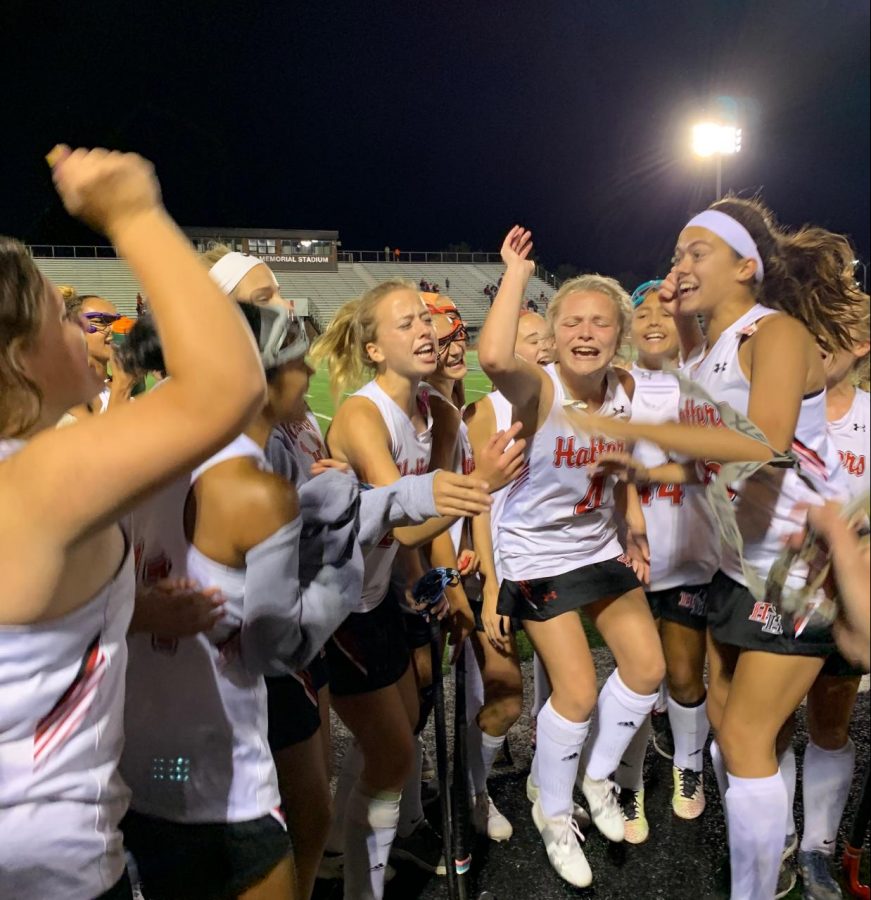 Paige Mullen, Maddie Gregory and Hannah Deal cheering with the team.