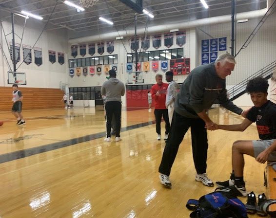 Coach Enoch talks with Adriel Tiburcio during tryouts.