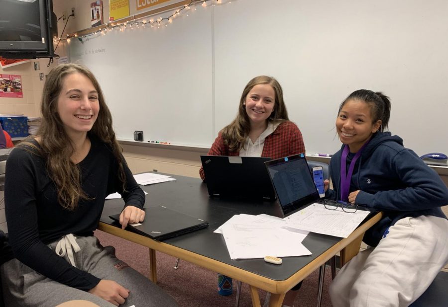 Ava Fuchs and Gretchen Reese tutoring Hannah Chan. 