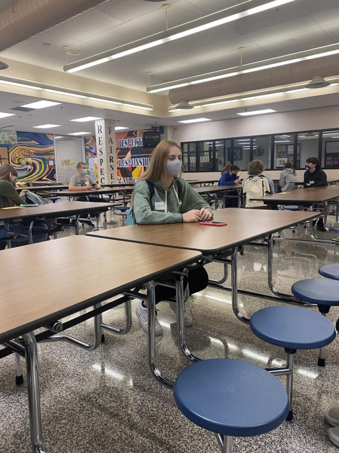 Students sit socially distanced in the cafeteria.