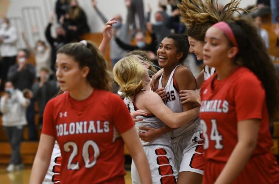 Senior Alice Hall celebrating one-thousandth point with teammates during game.